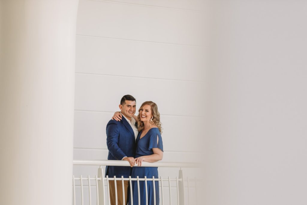 Woman in blue dress with man in blue blazer during their Fernbank engagement session