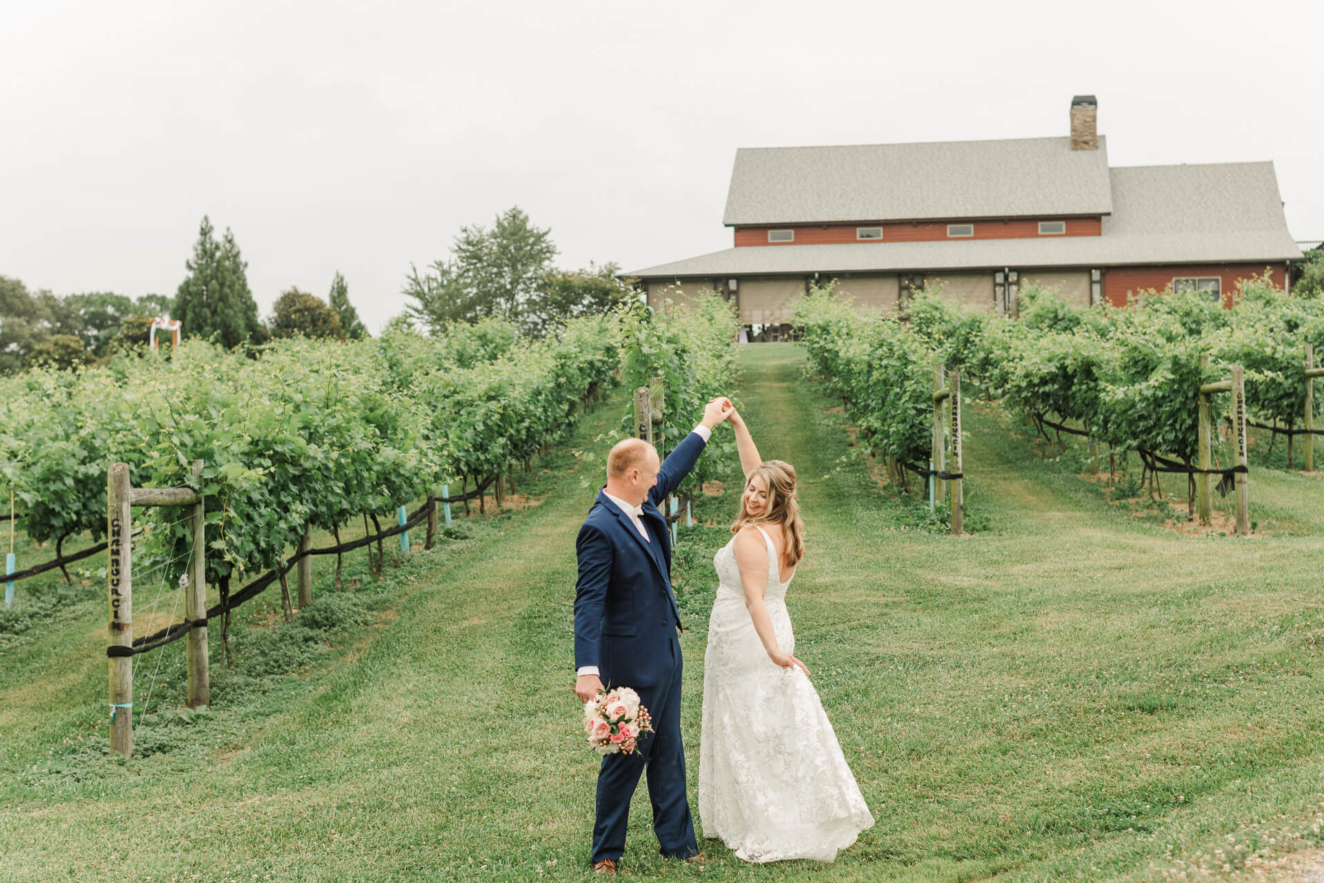 Bride and groom dancing outside CeNita winery among the grape vines, georgia wedding venue